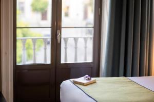 Postel nebo postele na pokoji v ubytování Itaca Jerez by Soho Boutique