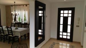 a dining room with a table and a mirror at Ferienhaus In Pedruscada Mit Privatem Pool in Cala Ratjada