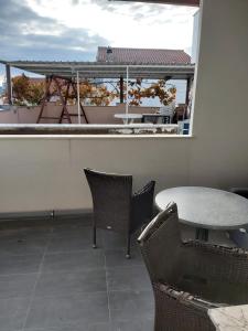 a patio with a table and chairs and a balcony at Eden in Vodice