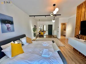 a bedroom with a bed and a living room at SINAI APH Apartments in Sinaia +290 photos