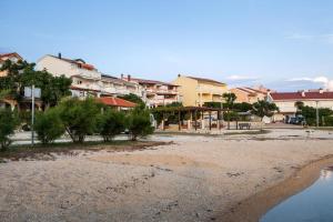 a view of a beach with houses in the background at Appartement Rajka in Kustići