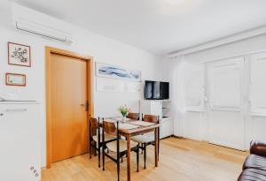 a kitchen and dining room with a table and chairs at Apartma Mama Bovec in Bovec