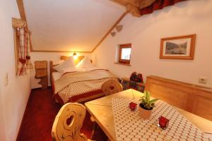 a small bedroom with a bed and a table at Ruhiges Appartement In St Gallenkirch in Sankt Gallenkirch