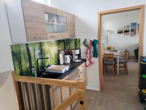 a kitchen with a sink and a counter top at Nette Wohnung In Großsteinberg Mit Grill Und Terrasse in Pomssen +5 photos