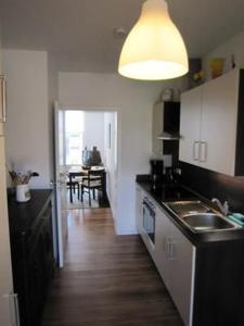 a kitchen with a sink and a counter top at Charmante Wohnung In Malchow in Malchow