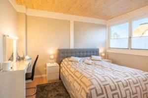 a bedroom with a bed and a desk and a window at Haus Am Yachthafen in Ostseebad Karlshagen +11 photos