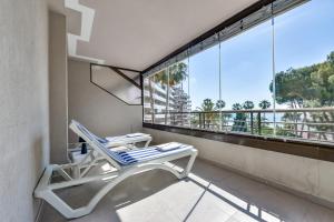 a chair on a balcony with a view of the city at Villas Guzman - Paraiso Mar in Calpe