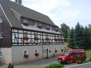 a red van parked in front of a building at Fewo Erzgebirge in Dorfchemnitz