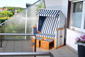 a chair on the balcony of a house at Ferienhaus In Tarnewitz Mit Terrasse in Tarnewitz