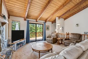 a living room with a couch and a tv at The Big Easy Lakefront Cabin in Groveland