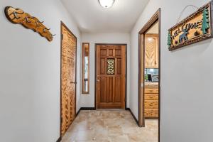 a hallway with a wooden door and a staircase at The Big Easy Lakefront Cabin in Groveland