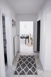 a white hallway with a black and white rug at Panoramablick Rhön in Sandberg