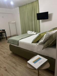 a bedroom with a bed and a book on a table at 500 Pit-Stop B&B - Milazzo in Milazzo