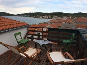 two chairs and a table on a deck with a view at Sommersprosse Terase in Betina