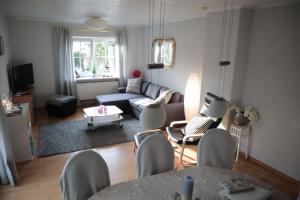 a living room with a couch and a table at Achtern Diek in Wendtorf