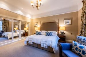 a bedroom with two beds and a large mirror at Marcliffe in Aberdeen
