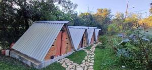 a row of wooden houses in a garden at Recanto Vale da Lua in Passa Quatro