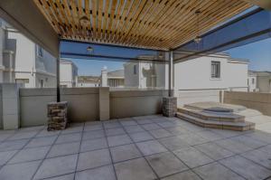 an outdoor patio with a wooden ceiling and a roof at La Vida Luxe in Fourways