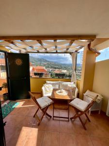 a patio with a table and chairs and a couch at Appartamento Sunshine in Badesi