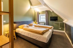 a bedroom with a bed in a room at Boerderij Hoeve met privé zwembad | 18 personen in Otterlo +51 photos