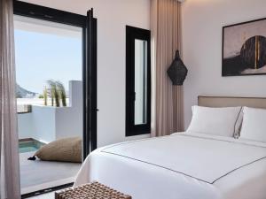 Cama ou camas em um quarto em Kalea Mykonos