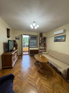 a living room with a couch and a table at Adriatic Escape Apartment in Herceg-Novi