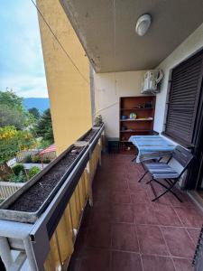 a balcony with tables and chairs on a building at Adriatic Escape Apartment in Herceg-Novi