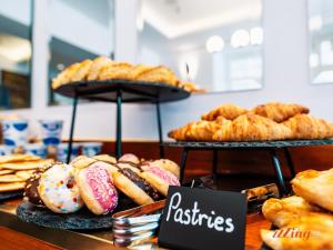 a bunch of pastries on display in a bakery at Yolanda Boutique Suites by Zzzing in Cospicua