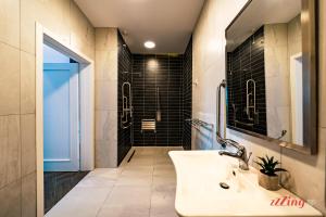 a bathroom with a sink and a shower at Yolanda Boutique Suites by Zzzing in Cospicua +44 photos