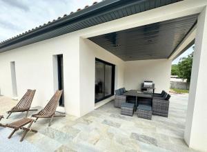 a patio with two chairs and a table at Villa Dyane in Salavas
