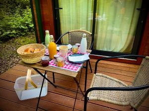 a picnic table with food and drinks on a porch at Hotel Les Lodges de Vaugrigneuse in Vaugrigneuse