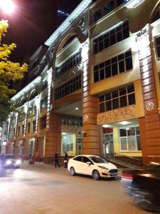 a white car parked in front of a building at Hotel Complex Kupecheskiy Dvor in Rostov on Don