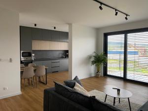 a living room with a couch and a table at Apartmán MDK in Námestovo
