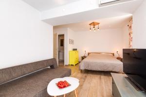 a bedroom with a bed and a living room with a couch at Yvonne in Krk