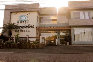 a hotel with a sign on the side of a building at Hotel Caminhos da Serra in Três Coroas