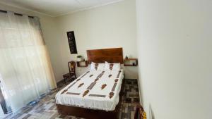 a bedroom with a large bed in a room at Bete Selam in Bahir Dar