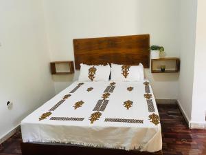 a bedroom with a large bed with gold decorations on it at Bete Selam in Bahir Dar +14 photos
