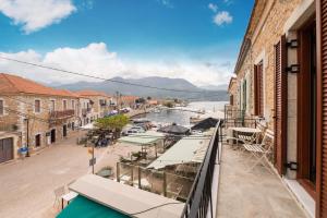 a balcony with a view of a river and buildings at Mani view luxury house in Agios Nikolaos