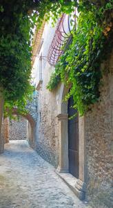 a stone building with a door on the side of it at Palazzo Caracciolo in Gerace +35 photos