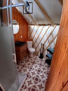 a bathroom with a toilet and a sink in a yurt at Yourte - Terracotta - Climatisée -Les Belles Ouvrières in Clermont-Créans