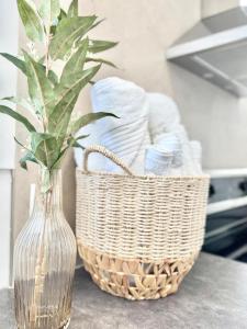 a glass vase with a plant in it next to a basket at Le Tulum 2 in Quebec City +33 photos