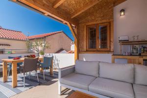 a patio with a couch and a table at Yvonne in Krk