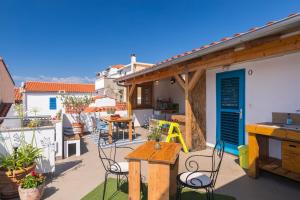 a patio with chairs and a table on a balcony at Yvonne in Krk