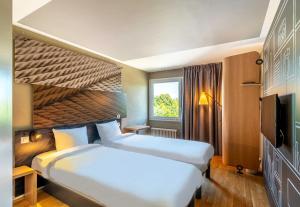 Postel nebo postele na pokoji v ubytování B&B HOTEL Rothrist Olten