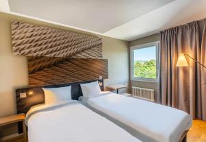 Postel nebo postele na pokoji v ubytování B&B HOTEL Rothrist Olten
