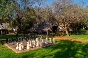 a chess board on a lawn in a yard at Kwa Maritane Lodge in Ledig