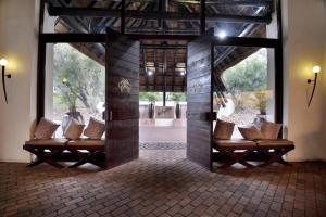 a room with a group of benches in a building at Kwa Maritane Lodge in Ledig
