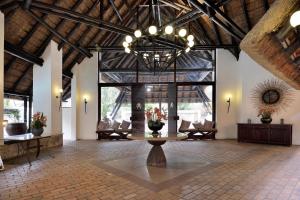 a large lobby with a table in the middle of a room at Kwa Maritane Lodge in Ledig