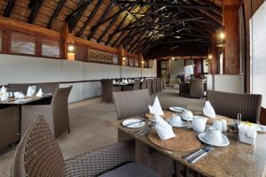 a dining room with a table and chairs at Kwa Maritane Lodge in Ledig