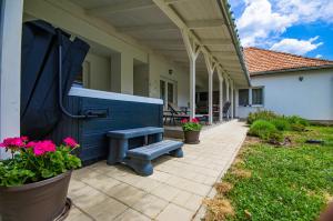 a porch with a bench on a house at Boutique Villa Gyula in Gyula